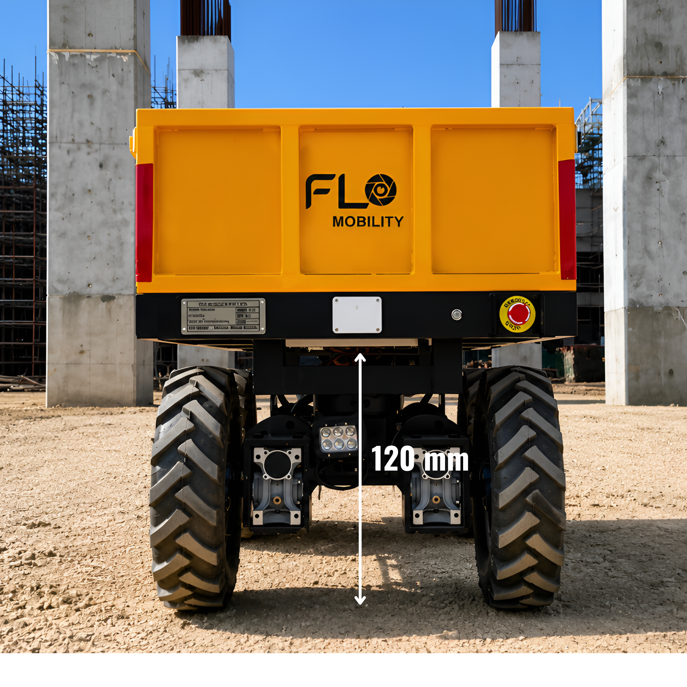 Flo Hauler Ground Clearance: 120mm Underbody Clearance for Rough Construction Site Terrain Front-facing view of the yellow Flo Hauler autonomous construction robot on dirt terrain, highlighting its 120mm ground clearance and heavy-duty treaded tires.